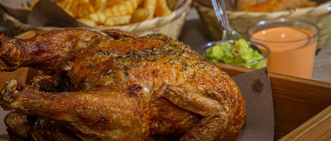 A fried turkey with sauce on the side