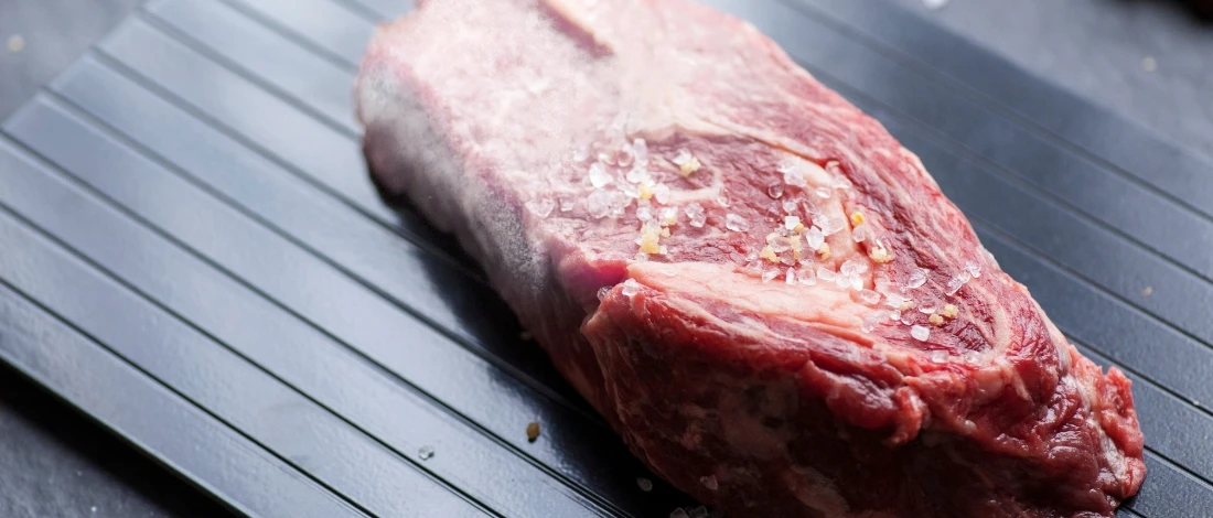 A meat defrosting on a tray