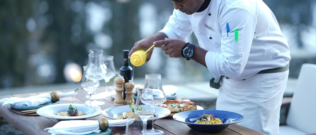 The chef preparing the dishes on the table