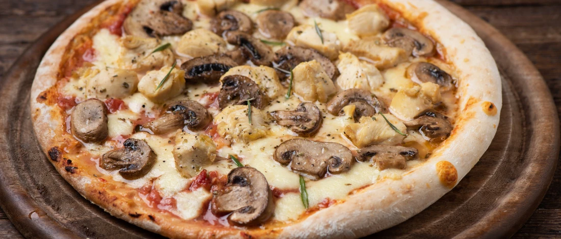 Mushrooms on a pizza set on table