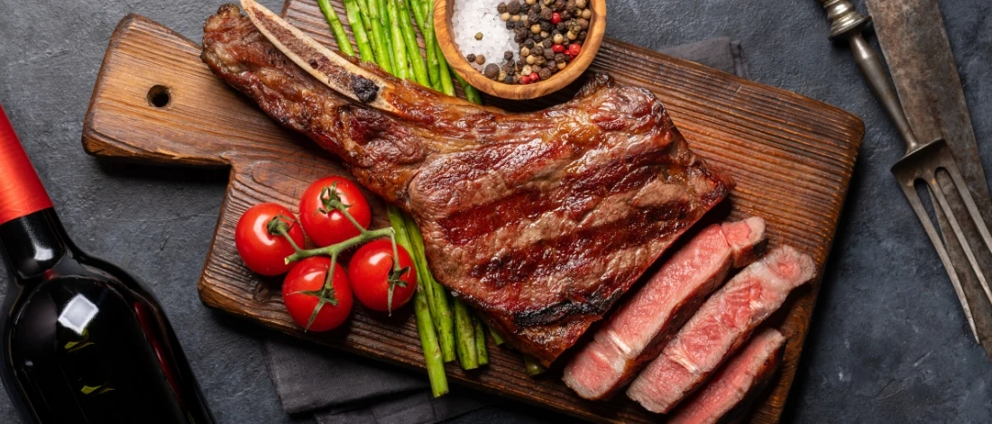 A sliced steak on a cutting board.