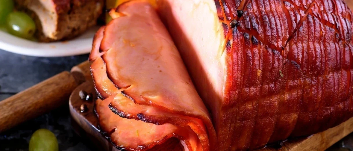 A baked ham steak sliced thinly