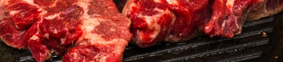 The flavorful steak cooking on a pan