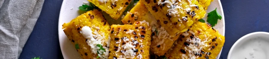 A roasted corn on a cob with butter on top