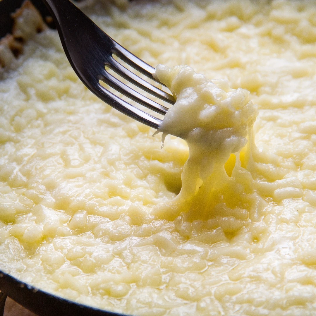 The cheese melting on a pan