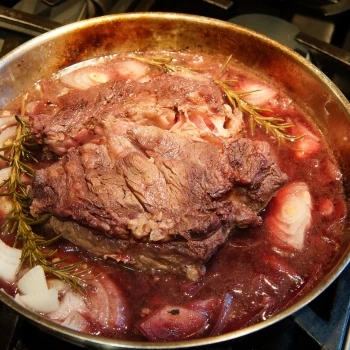 The steak cooking in a pan