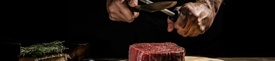 The chef is preparing the meat