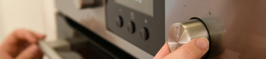 A person pre-heating the oven