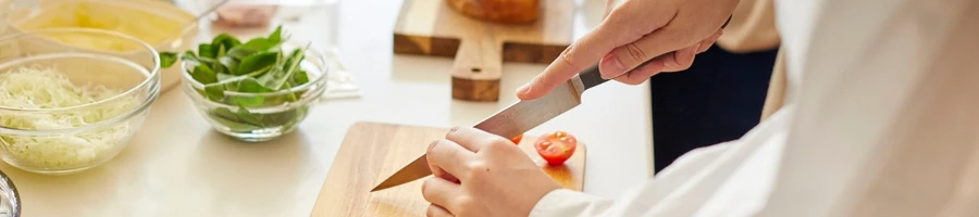 A person preparing the ingredients for sandwich