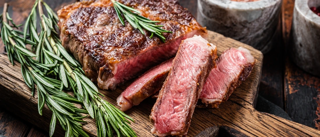 A perfectly cooked steak on a wooden board