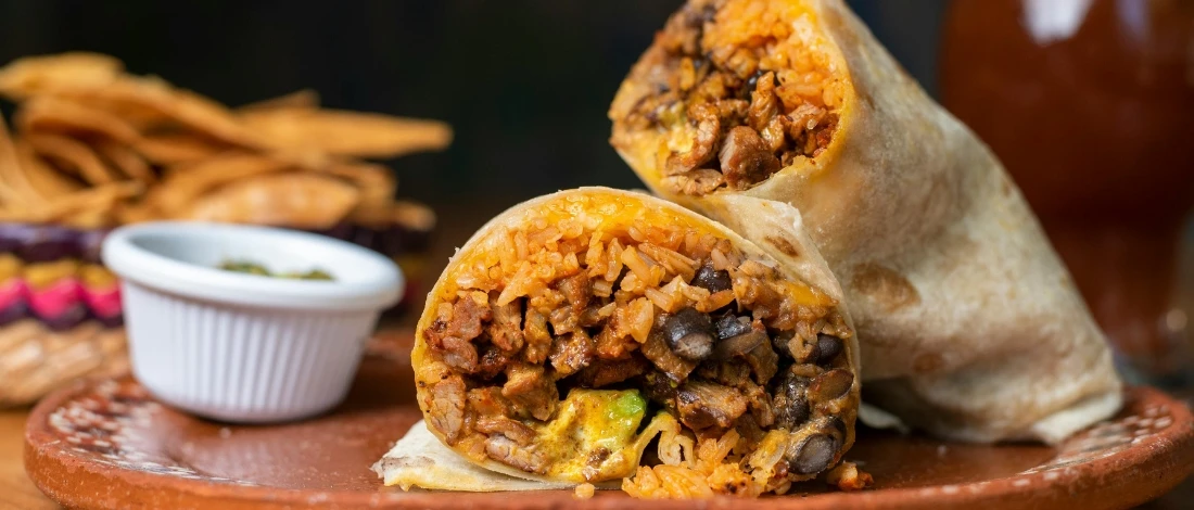 A perfectly made burritos with ranchero sauce