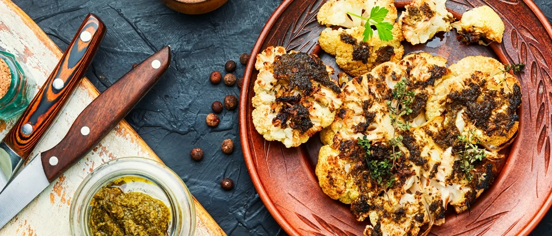 A delicious roasted cauliflower steak on a plate
