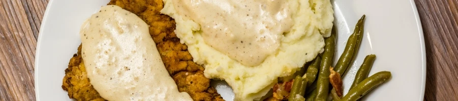 A top view of chicken fried steak on a plate