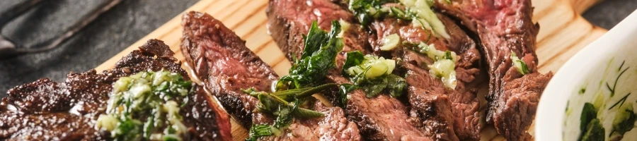A juicy steak with chimichurri sauce