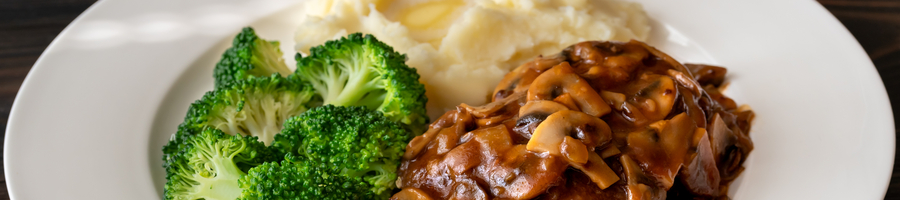 Salisbury steak with steamed broccoli and mashed potato